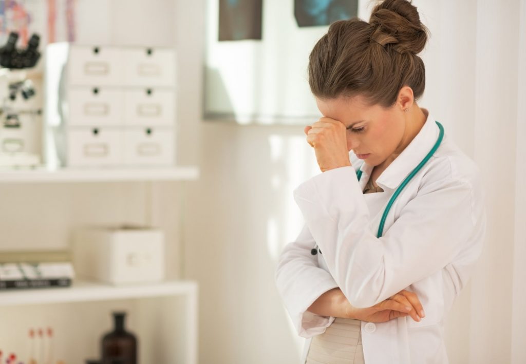 Portrait of stressed doctor woman in office depressed doctor