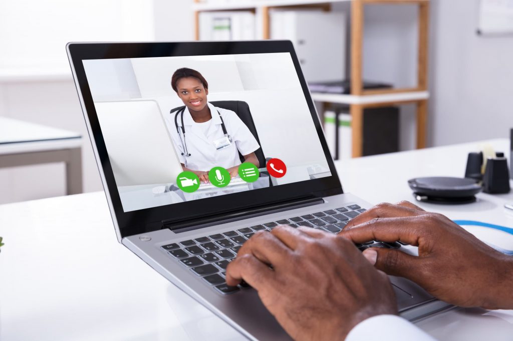 Person Video Conferencing With Female Doctor Through Laptop telemedicine
